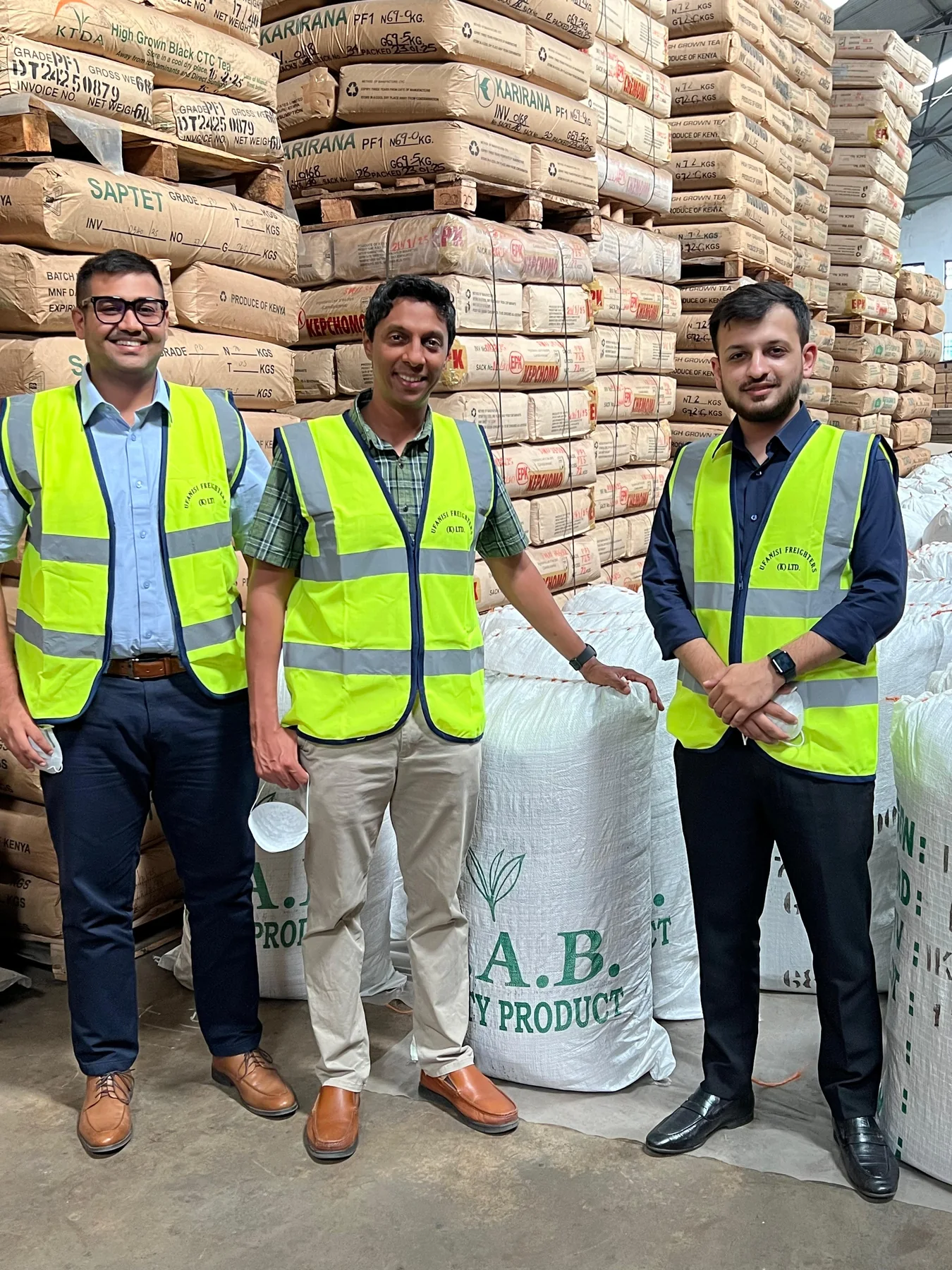 Tea-industry visitors at a warehouse storing packaged tea